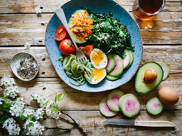 Salad with avocado, eggs, and tomato on a table